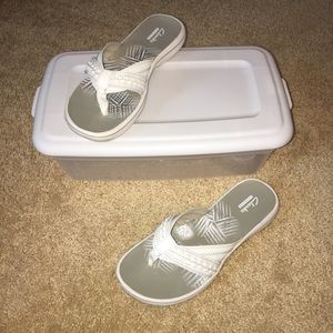 Clark’s white flip-flops